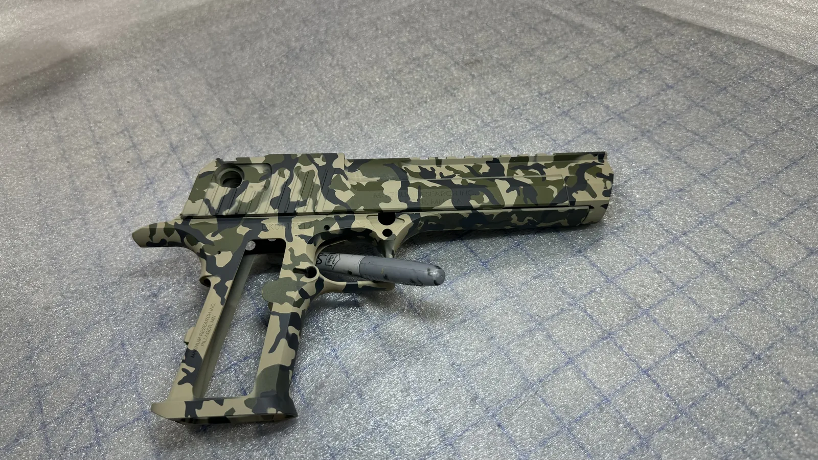 Custom multicam Cerakote finish on a pistol by Advanced Coatings
